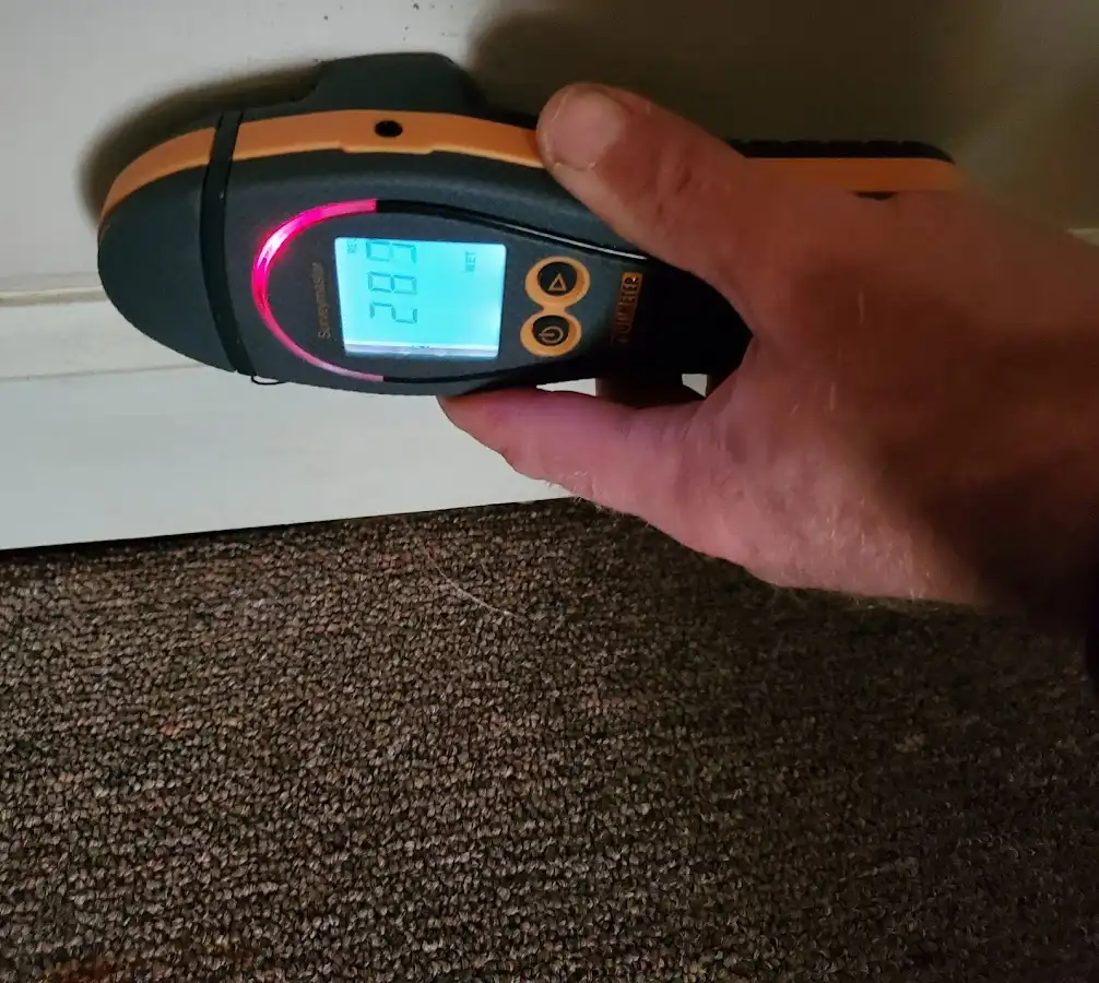 Moisture detection at baseboard during Storm Damage Restoration in Fairport